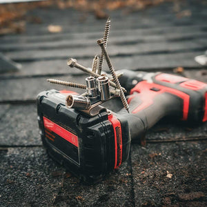 A close-up of a power drill equipped with a Second Set Magnet holding multiple screws and drill bits securely, demonstrating its strong magnetic capabilities on a work surface.