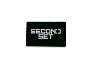 A black rectangular magnet featuring the white "Second Set" logo, showcasing a sleek and durable design for tool organization and productivity.