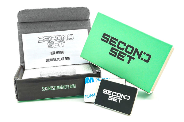 Second Set packaging displayed with a black box, green manual, user instructions, and black rectangular magnets with 'Second Set' logo. The website 'secondsetmagnets.com' is printed on the front of the box.